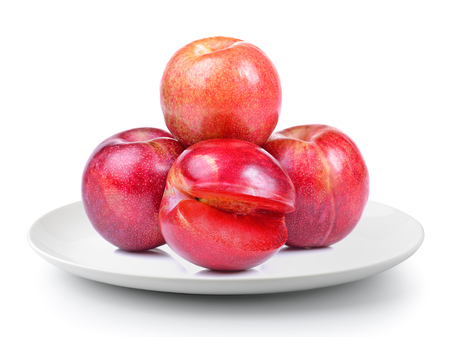 plum in a plate isolated on a white backgroundの写真素材