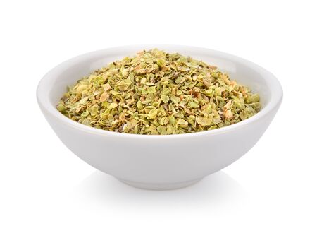 Oregano spice in a bowl on white backgroundの写真素材