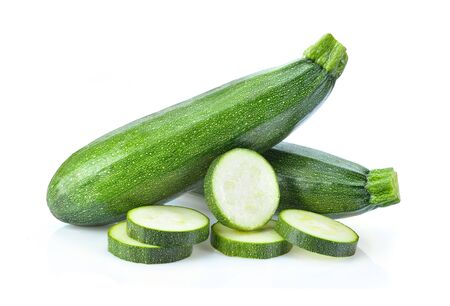 fresh green zucchini with slice isolated on white backgroundの写真素材