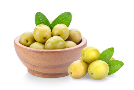 green olives in wood bowl on a white backgroundの写真素材