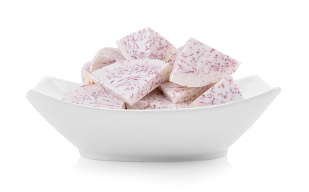 slice taro root in a bowl on white backgroundの写真素材