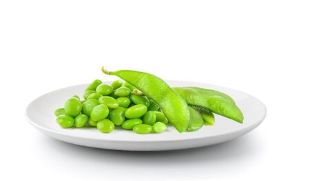 soy beans in plate isolated on a white backgroundの写真素材