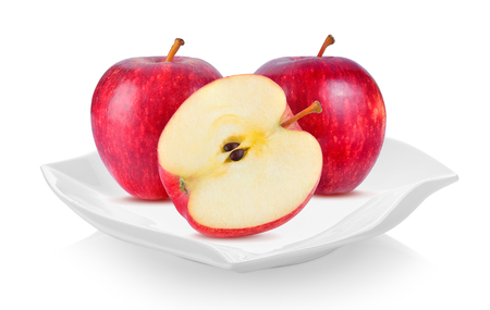 red apple in ceramic plate (beautiful shape) on white backgroundの写真素材