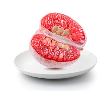 Grapefruit piece in a plate isolated on a white backgroundの写真素材