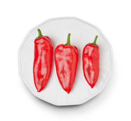 Sweet pepper in a plate on white backgroundの写真素材