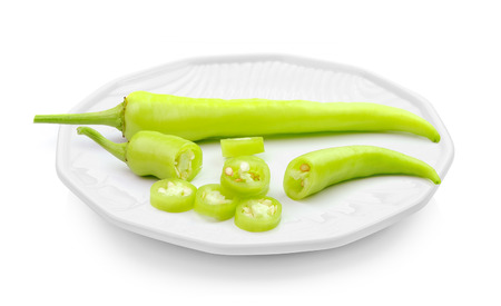 Green hot chili pepper in a plate isolated on white backgroundの写真素材