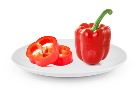 red sweet pepper in plate isolated on white backgroundの写真素材