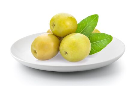 green olives in a plate isolated on a white backgroundの写真素材