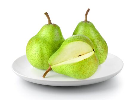 green pears in plate isolated on a white backgroundの写真素材