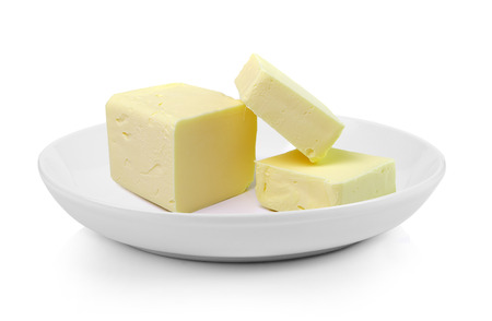 Stick of butter in plate on white backgroundの写真素材