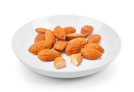 almond in plate on white backgroundの写真素材
