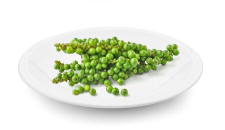 green pepper corn in plate on white backgroundの写真素材