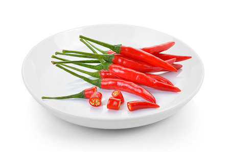 red chili peppers in plate on white backgroundの写真素材