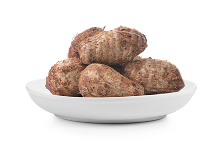 taro root in plate on white backgroundの写真素材