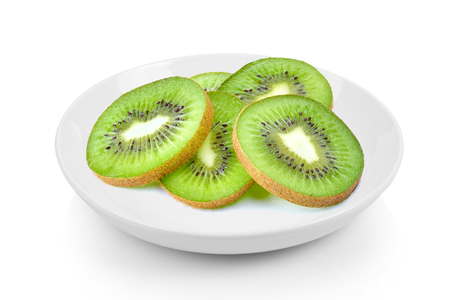 slices kiwi in  plate on white backgroundの写真素材