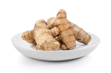 fresh turmeric  in plate on white backgroundの写真素材