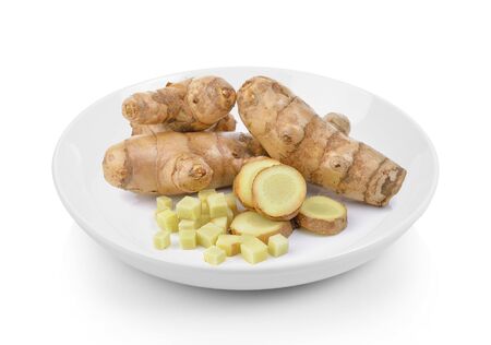 fresh turmeric in plate on white backgroundの写真素材