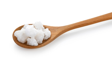 salt in wood spoon on white backgroundの写真素材