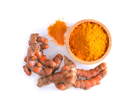 curcuma powder in a bowl and root on white backgroundの写真素材
