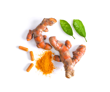 turmeric (Curcuma) powder pile with leaf isolated on white backgroundの写真素材
