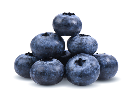 Blueberries with green leaves closeup, isolated on white backgroundの写真素材