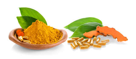 fresh turmeric and turmeric capsules on white backgroundの写真素材