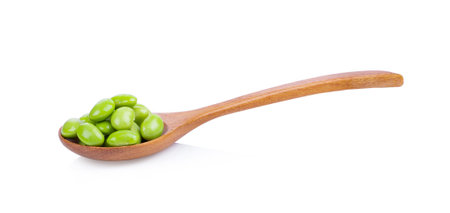 green soybeans in wood spoon isolated on white backgroundの写真素材