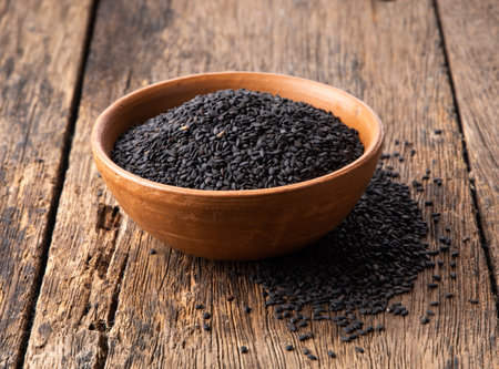 sesame seeds in a ceramic bowl on woodenの写真素材