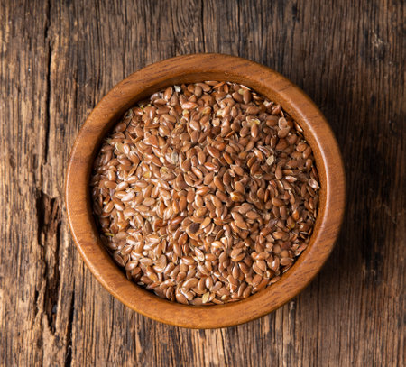 flax seeds in wood bowlの写真素材