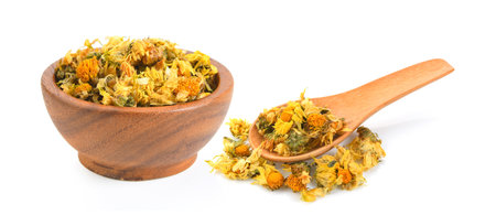 dried chrysanthemum flowers inj wood bowl and spoon on white backgroundの写真素材