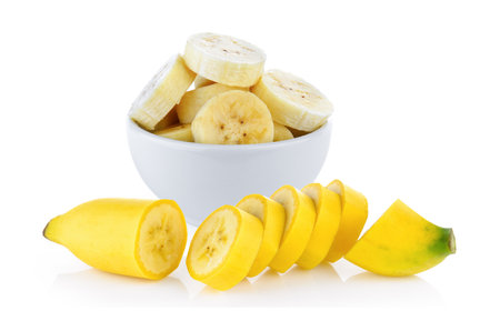 slice banana in white bowl on white backgroundの写真素材