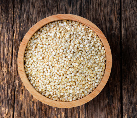 Quinoa in a bowl on wood tableの写真素材