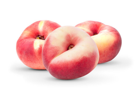 flat donut peaches isolated on white backgroundの写真素材