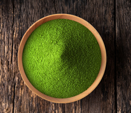 Green tea powder in a bowl on woodenの写真素材
