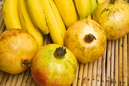 Pomegranates and bananasの写真素材