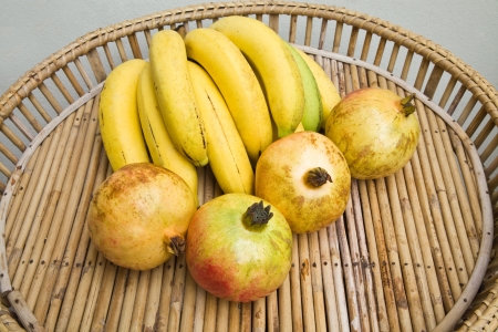 Pomegranates and bananasの写真素材