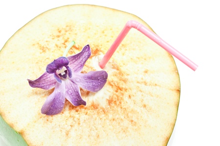 Coconut drinking and blue orchid isolated on whiteの写真素材