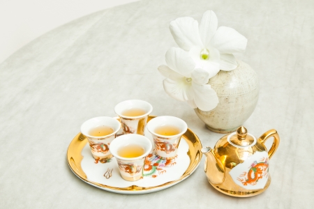 Gold chinese tea set on marble tableの写真素材