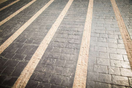 Black and yellow cobblestone walkway