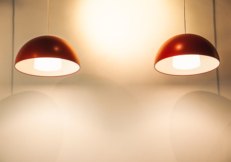Warm lighting from red lamps on ceilingの写真素材