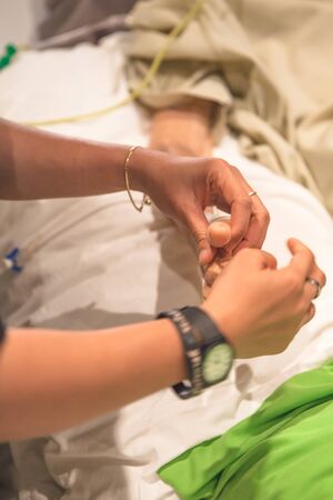 Physical therapy exercises for elderly patient's hand in hospitalの写真素材