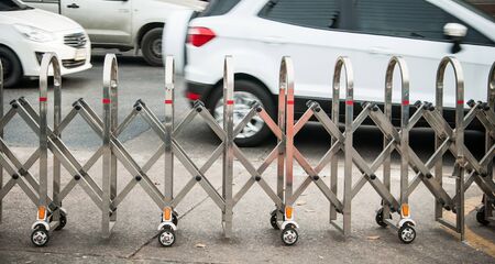 Stainless steel fence along the Many wheels for moving trafficの写真素材