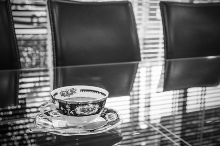 Coffee cup on glass table in meeting roomの写真素材