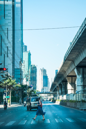 Women across the street on the crosswalk at Sathorn Road Bangkok Thailandの写真素材
