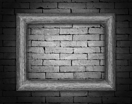 Old picture frames on brick wallの写真素材