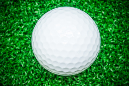 White golf ball on artificial grass, Backgroundsの写真素材
