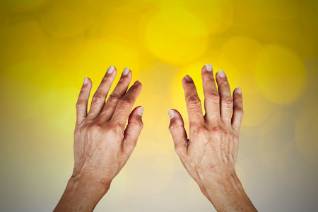 Female hands isolated on yellowの写真素材