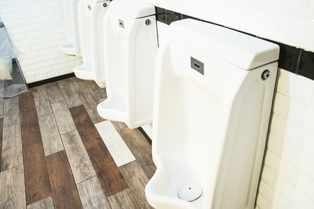 Row of four urinals in mens toilet, Backgroundsの写真素材