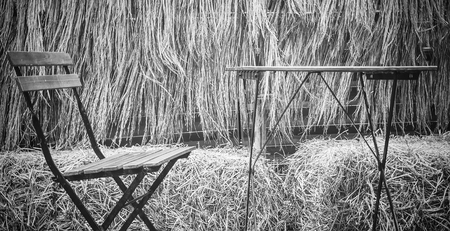 Outdoor tables and chairs outdoor with rice straw backgroundの写真素材