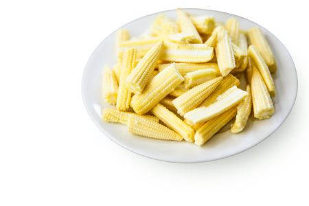 Fresh raw baby corn in white plate isolated on whiteの写真素材